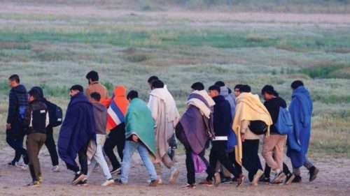 Migrants walk back to their makeshift camp after a failed attempt to cross the Channel to the UK on ...