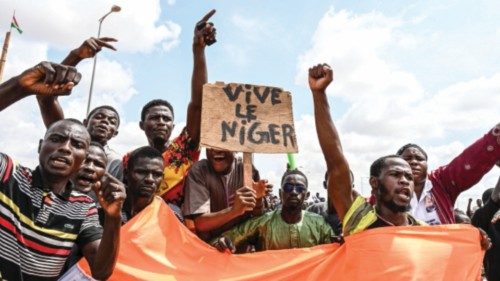 TOPSHOT - Supporters of the Niger's National Council for the Safeguard of the Homeland (CNSP) wave a ...