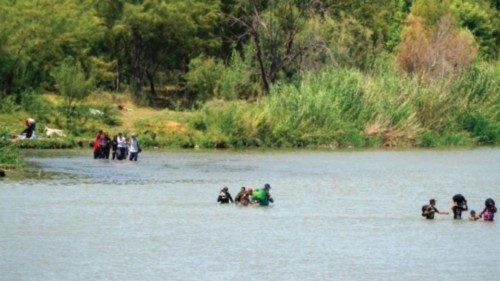 Migrants cross the Rio Grande from Mexico into the US in Eagle Pass, Texas on August 25, 2023. ...