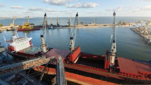 Big grain terminal at seaport. Cereals bulk transshipment from road transport to vessel. Loading ... Big grain terminal at seaport. Cereals bulk transshipment from road transport to vessel. Loading ...