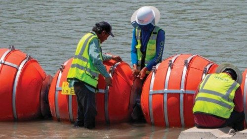 (FILES) Workers provide maintenance to the blades between the buoys placed along the Rio Grande ...