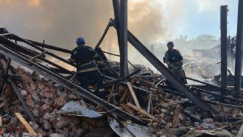 Firefighters work at a site of a Russian missile strike, amid Russia's attack on Ukraine, in Kryvyi ...