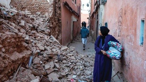 A woman looks at the rubble of a building in the earthquake-damaged old city in Marrakesh on ...