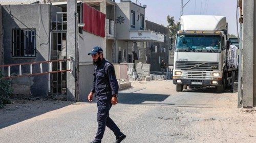A Palestinian police officer loyal to Hamas stands before freight trucks parked at the Kerem Shalom ...
