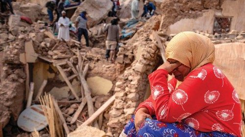 A woman reacts by the rubble of destroyed buildings in the aftermath of the deadly 6.8-magnitude ...