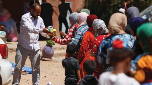 Women and children queue for aid, in the aftermath of a deadly earthquake, in Tinmel, Morocco, ...