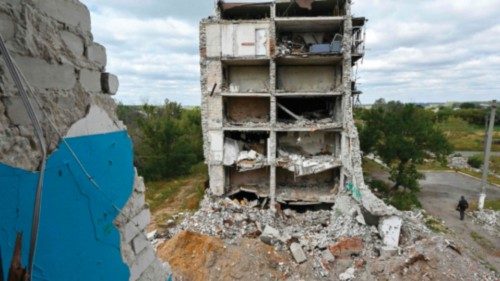 TOPSHOT - A person walks past a residential building destroyed as a result of hostilities in 2022 in ... TOPSHOT - A person walks past a residential building destroyed as a result of hostilities in 2022 in ...