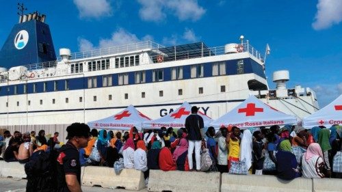 A group of migrants wait on the island of Lampedusa as Italian authorities prepare for transferring ... A group of migrants wait on the island of Lampedusa as Italian authorities prepare for transferring ...