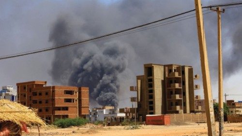 FILE PHOTO: Smoke rises above buildings after an aerial bombardment during clashes between the ...