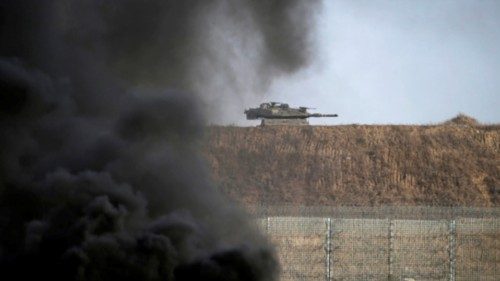 epa10859128 An Israeli tank behind the border wall during clashes with Israeli troops on the eastern ...