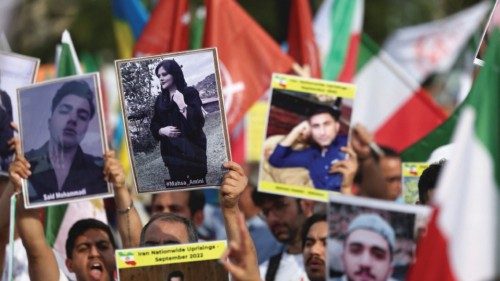 A person holds a picture of Mahsa Amini, as Iranian diaspora in Europe take part in a rally on the ...