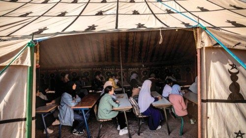 Students attend class in a tent at a make-shift school in the earthquake-hit village of Asni in ...