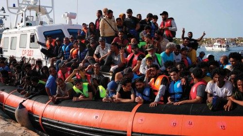 TOPSHOT - Migrants arrive in the harbour of Italian island of Lampedusa, on September 18, 2023. ...