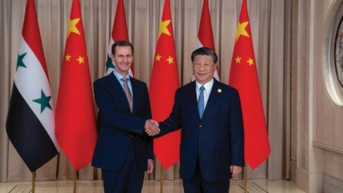 Chinese President Xi Jinping shakes hands with Syria's President Bashar al-Assad in eastern Hangzhou ...
