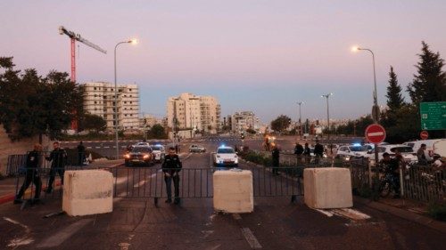 Israeli policemen place cement blocks across a road linking the east Jerusalem Arab neighbourhood of ...