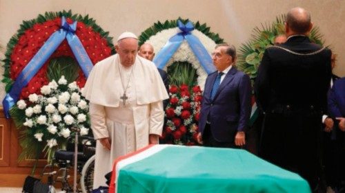 A handout photo made available by the Vatican Media shows Pope Francis paying respect at the coffin ...