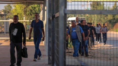 Palestinian workers gather at the Erez crossing between Israel and the northern Gaza Strip, on ...