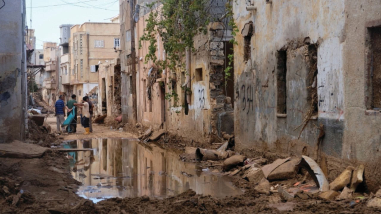 People clean their homes which were impacted by fatal floods in Derna, Libya, September 28, 2023. ...