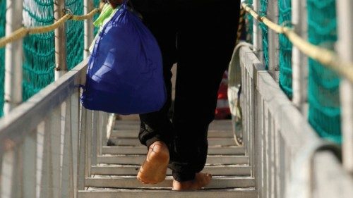 FILE PHOTO: A migrant disembarks from the Geo Barents rescue ship, operated by Medecins Sans ... FILE PHOTO: A migrant disembarks from the Geo Barents rescue ship, operated by Medecins Sans ...