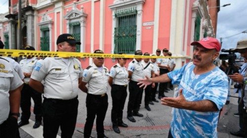 A man protests in front of police officers guarding the headquarters of the Supreme Electoral ...