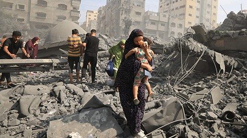 TOPSHOT - Palestinians evacuate the area following an Israeli airstrike on the Sousi mosque in Gaza ... TOPSHOT - Palestinians evacuate the area following an Israeli airstrike on the Sousi mosque in Gaza ...