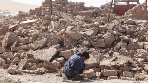 A boy cries as he sits next to debris, in the aftermath of an earthquake in the district of Zinda ...