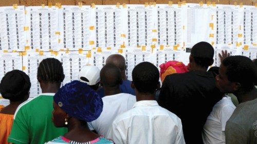 epa10910738 Liberian citizens search for their names before casting their votes during the ...