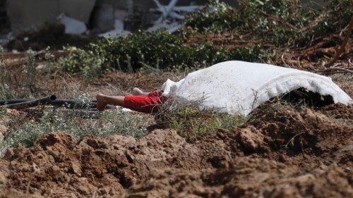 epa10911397 Dead bodies lie on ground in Kfar Aza kibbutz next to the border with Gaza, 10 October ...