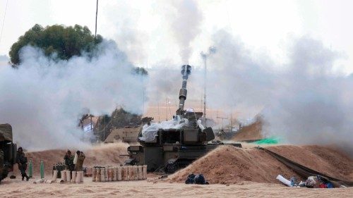 EDITORS NOTE: Graphic content / Israeli soldiers block their ears as a M109 155mm self-propelled ...