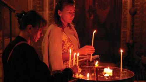 Visitors light candles in the Church of the Holy Sepulchre in the Christian quarter of the ...