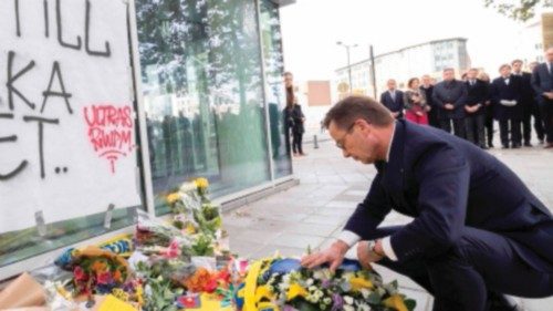 Swedish Prime Minister Ulf Kristersson lays down flowers during a commemoration for the victims of ...
