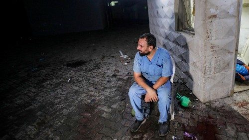 epa10924873 A doctor at the scene of Al Ahli hospital after an air strike in Gaza City, 17 October ...