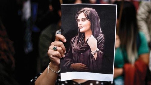 (FILES) A protester holds a portrait of Mahsa Amini during a demonstration in her support in front ...