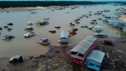 TOPSHOT - Floating houses and boats are seen stranded at the Marina do Davi, a docking area of the ...