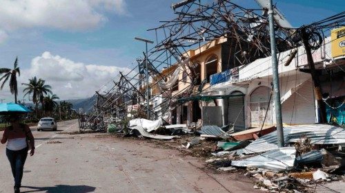 Residents walk past debris in the aftermath of hurricane Otis  in Acapulco, Guerrero State, Mexico, ...
