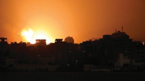 The sky lites up as a building is hit during an Israeli air strike on Gaza City late on November 2, ...