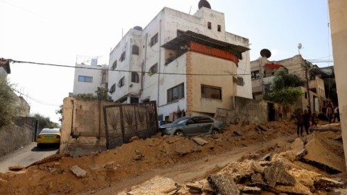 epa10955743 Palestinians inspect the damage at an area following an Israeli raid at Jenin refugee ...