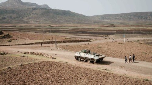 (FILES) People walk near a tank of alleged Ethiopian army that is abandoned on the road near ...