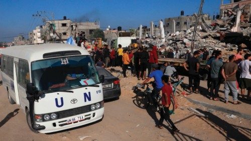 EDITORS NOTE: Graphic content / A UN bus drives past a destroyed building following the Israeli ...