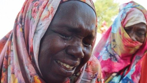 Women from the city of Al-Junina (West Darfur) cry after receiving the news about the death of their ...