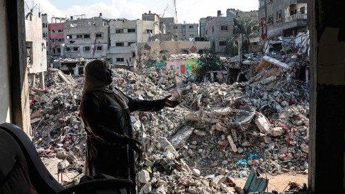 A Palestinian woman gestures as she explains how her home was destroyed duing the Israeli ...