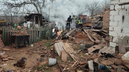 Firefighters work at the site where houses were damaged by a Russian drone strike, amid Russia's ...
