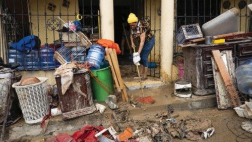 epa10985359 People remove mud from their home after torrential rains in Santo Domingo, Dominican ...