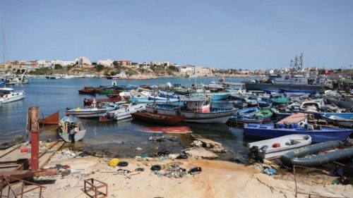 FILE PHOTO: Migrants arrive on an Italian Coast Guard vessel after being rescued at sea, on the ...