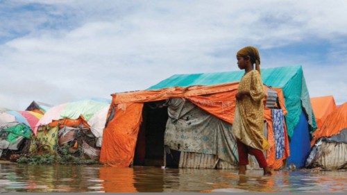 Residents wade through flood waters within their makeshift shelters at the Al-Hidaya camp for the ... Residents wade through flood waters within their makeshift shelters at the Al-Hidaya camp for the ...