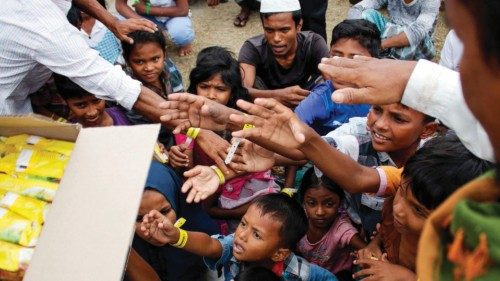 Rohingya people receive donations at an immigration building in Lhokseumawe, Aceh province on ... Rohingya people receive donations at an immigration building in Lhokseumawe, Aceh province on ...