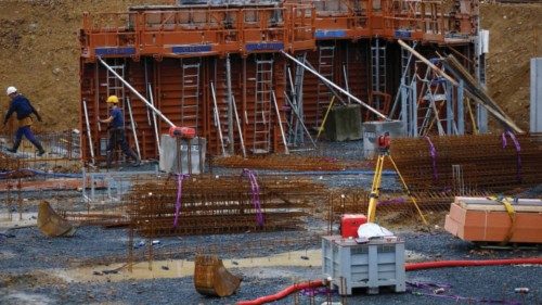 Men work at a contruction site for new residential apartment buildings in Les Sorinieres near ... Men work at a contruction site for new residential apartment buildings in Les Sorinieres near ...