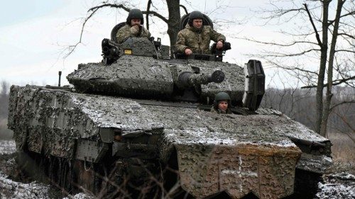 Ukrainian servicemen check their Sweden made CV90 armored infantry combat vehicle on a position ...