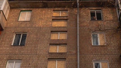 A man fixes a window in an apartment building that was damaged during a recent Russian drone attack, ...