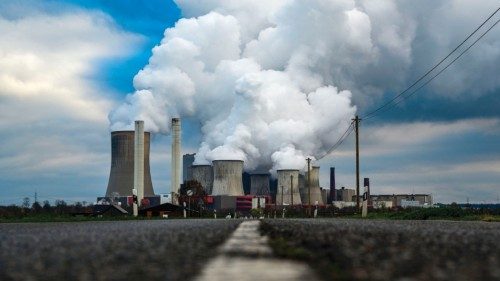 Vapor rises from the cooling towers of the lignite-fired power station operated by German energy ...